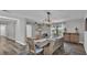 Dining room with wood-look floors, bench seating and modern light fixture at 1433 Ellison Ln, Lakeland, FL 33801