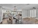 Open concept dining room with views of the kitchen and living spaces and access to the lanai at 1433 Ellison Ln, Lakeland, FL 33801