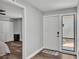 Bright entryway with gray walls, wood floors, and a door with a side window for natural light at 1433 Ellison Ln, Lakeland, FL 33801