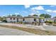 Spacious single-story home featuring a large concrete driveway, manicured lawn, and decorative landscaping at 1433 Ellison Ln, Lakeland, FL 33801