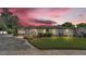 Charming single-story home with green lawn, updated landscaping and long driveway at 1433 Ellison Ln, Lakeland, FL 33801