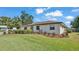 Well-maintained single-story home with a landscaped front yard and healthy green grass in a residential neighborhood at 1433 Ellison Ln, Lakeland, FL 33801