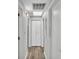 Hallway featuring neutral paint, wood floors and closet doors at 1433 Ellison Ln, Lakeland, FL 33801