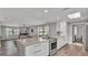 Open kitchen featuring a large island, stainless appliances, and a seamless flow to the dining area at 1433 Ellison Ln, Lakeland, FL 33801