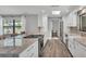 Modern kitchen with white cabinets, granite countertops, and stainless steel appliances at 1433 Ellison Ln, Lakeland, FL 33801