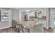Bright kitchen featuring white cabinets, stainless steel appliances, and a large center island with seating at 1433 Ellison Ln, Lakeland, FL 33801
