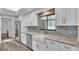 Bright kitchen featuring white cabinets, stainless steel appliances, and a farmhouse style sink at 1433 Ellison Ln, Lakeland, FL 33801