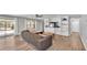 Spacious living room with built-in storage, wood-look flooring, and a sliding glass door to the backyard at 1433 Ellison Ln, Lakeland, FL 33801