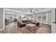 Spacious living room with wood-look floors, neutral paint, and a large window with natural light at 1433 Ellison Ln, Lakeland, FL 33801
