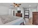 Cozy bedroom with wood-look flooring, a ceiling fan and a view into the ensuite bathroom at 1433 Ellison Ln, Lakeland, FL 33801
