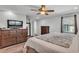 Spacious bedroom featuring wood flooring, ceiling fan, and large dresser at 1433 Ellison Ln, Lakeland, FL 33801