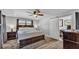 Bedroom with a wooden bed, a sliding barn door to the bathroom, and a ceiling fan at 1433 Ellison Ln, Lakeland, FL 33801