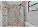 Shower featuring decorative tilework, shower head, and updated hardware at 1433 Ellison Ln, Lakeland, FL 33801
