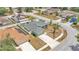 Aerial view of a landscaped home with a fenced yard, storage shed, and neighboring houses with solar panels at 1520 Caroline Ct, Bartow, FL 33830