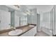 Bathroom features double sinks, granite counters, a shower, and a soaking tub at 1520 Caroline Ct, Bartow, FL 33830