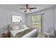 Light bedroom boasts bright decor, lots of natural light, carpeted floor and a ceiling fan at 1520 Caroline Ct, Bartow, FL 33830