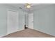 Bedroom featuring plush carpet, a ceiling fan, and double closets at 1520 Caroline Ct, Bartow, FL 33830