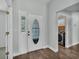 Bright entryway with decorative glass door, wood-look flooring, and convenient laundry access at 1520 Caroline Ct, Bartow, FL 33830