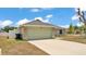 A single-story home featuring a two car garage, stone accents, and a well-manicured lawn at 1520 Caroline Ct, Bartow, FL 33830