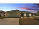 Charming single-story home with a two-car garage, landscaped front yard, and neutral toned exterior paint at 1520 Caroline Ct, Bartow, FL 33830