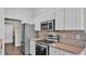 Kitchen featuring stainless steel appliances, including a refrigerator, microwave, and range at 1520 Caroline Ct, Bartow, FL 33830