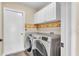 Modern laundry room with white cabinetry and stainless steel washer and dryer at 1520 Caroline Ct, Bartow, FL 33830