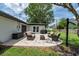 This serene backyard features a patio seating area and a manicured lawn with a white fence at 1536 Del Crest Pl, Lakeland, FL 33803
