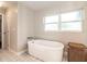 Bathroom featuring a standalone tub and decorative floors and trim at 1536 Del Crest Pl, Lakeland, FL 33803