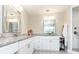 Bathroom vanity area with dual mirrors, decorative floors, and granite countertops at 1536 Del Crest Pl, Lakeland, FL 33803