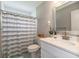 Bathroom featuring a white vanity, stylish mirror, and a shower-tub combo with a striped curtain at 1536 Del Crest Pl, Lakeland, FL 33803