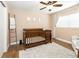 Bedroom featuring a ceiling fan, decorative ladder, and a wood-finished crib at 1536 Del Crest Pl, Lakeland, FL 33803
