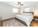 Bright bedroom featuring a ceiling fan, wood floors, and a decorative rug at 1536 Del Crest Pl, Lakeland, FL 33803