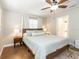 Bedroom with wood floors, a ceiling fan, and a view to the bathroom at 1536 Del Crest Pl, Lakeland, FL 33803