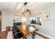 Dining area featuring a modern light fixture, wooden table, and view into living room at 1536 Del Crest Pl, Lakeland, FL 33803