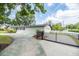 Long driveway leading to a white home with a black gated entrance and a well-kept yard at 1536 Del Crest Pl, Lakeland, FL 33803