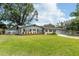 Charming single-story home with manicured lawn, tasteful brick accents, and dark shutter details at 1536 Del Crest Pl, Lakeland, FL 33803