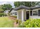 Inviting front porch featuring a stylish black front door, manicured shrubs, and black accent shutters at 1536 Del Crest Pl, Lakeland, FL 33803