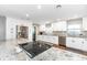 Renovated kitchen featuring stainless steel appliances and an island with a granite countertop at 1536 Del Crest Pl, Lakeland, FL 33803
