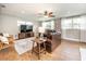 Cozy living room featuring a leather sofa, wood-look tile floors, and natural light at 1536 Del Crest Pl, Lakeland, FL 33803