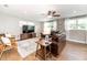 Cozy living room featuring a leather sofa, natural light, and ceiling fan at 1536 Del Crest Pl, Lakeland, FL 33803