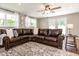 Open-concept view of living room featuring a comfortable L-shaped sofa and view to the exterior at 1536 Del Crest Pl, Lakeland, FL 33803