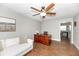 Office with a wooden desk, white couch, ceiling fan, and wood look tile flooring at 1536 Del Crest Pl, Lakeland, FL 33803