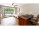 Office with a wooden desk, a white couch, large window and wood look tile flooring at 1536 Del Crest Pl, Lakeland, FL 33803