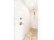 All-white walk-in shower with stone pebble flooring and dual shower heads at 1536 Del Crest Pl, Lakeland, FL 33803