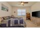 Inviting bedroom with ceiling fan, window, comfortable chair and wooden dresser at 1620 Linz Ct, Winter Haven, FL 33884