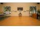 Large open space in the clubhouse with beautiful windows, a TV, a piano, and plenty of room for activities at 1620 Linz Ct, Winter Haven, FL 33884