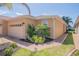 Charming home with manicured landscaping, a paver walkway, and a beige-colored exterior at 1620 Linz Ct, Winter Haven, FL 33884