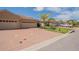 Exterior shot featuring a long driveway and beige-colored residences with tropical landscaping at 1620 Linz Ct, Winter Haven, FL 33884