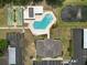 Aerial view of the community clubhouse, shuffleboard courts, swimming pool, and parking area at 2025 Sylvester Rd # E2, Lakeland, FL 33803