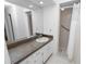 Bathroom featuring a shower, vanity with a mirror, and ample lighting; white and bright at 2025 Sylvester Rd # E2, Lakeland, FL 33803